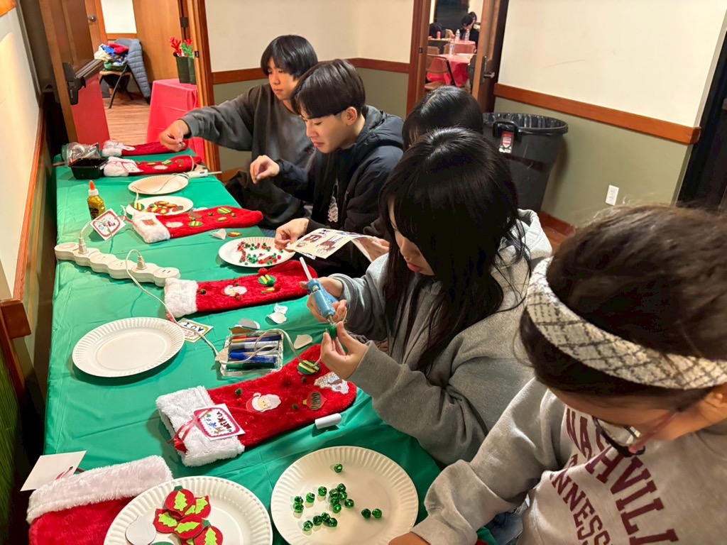 フィールド市派遣学生が靴下にクリスマスの飾りつけを行う様子